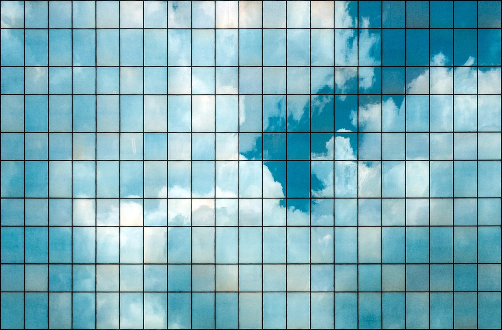 Clouds reflected in the glass facade of a tower on Avenida Paulista, São Paulo