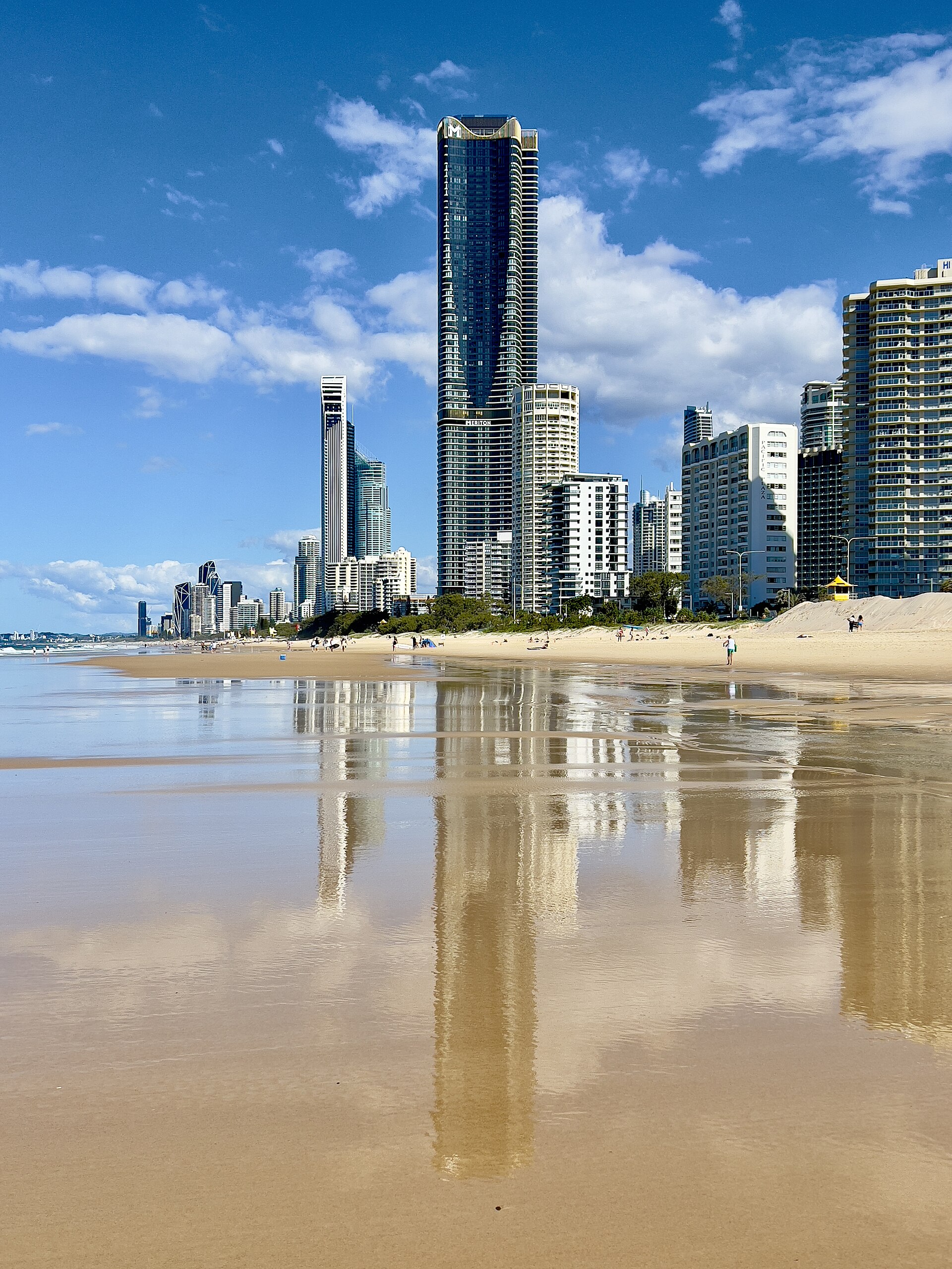Surfers Paradise towers reflected in the wet sand at low tide